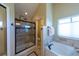 Bathroom showcasing a glass shower, soaking tub, and window at 1881 Alma Ln, Superior, CO 80027