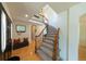 Foyer with wood floors, curved staircase with iron railings, and bench seating with red pillows at 1881 Alma Ln, Superior, CO 80027