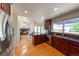 Open kitchen with dark wood cabinetry, stainless steel appliances, and wood flooring open to the dining and living areas at 1881 Alma Ln, Superior, CO 80027