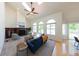 Light-filled living room boasts a fireplace, vaulted ceilings, and large windows at 1881 Alma Ln, Superior, CO 80027