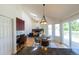 Dining space open to a living room with a vaulted ceiling and access to a deck at 1881 Alma Ln, Superior, CO 80027