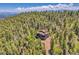 Stunning aerial view of a secluded home nestled in a dense forest with mountain views at 11333 Conifer Mountain Rd, Conifer, CO 80433
