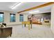 Spacious basement with a foosball table, pinball machine, and a mural on the wall at 11333 Conifer Mountain Rd, Conifer, CO 80433
