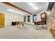 Spacious basement with a foosball table, pinball machine, and a mural on the wall at 11333 Conifer Mountain Rd, Conifer, CO 80433
