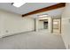 Spacious basement with a wood beam and an open doorway at 11333 Conifer Mountain Rd, Conifer, CO 80433