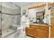 Bathroom features a glass shower with bench, single sink vanity, and granite countertop at 11333 Conifer Mountain Rd, Conifer, CO 80433