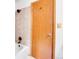 Light wood door next to bath tub and tiled shower area in bathroom at 11333 Conifer Mountain Rd, Conifer, CO 80433