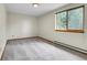 Bedroom with neutral walls, carpeted floor, and view to the outdoors through a window at 11333 Conifer Mountain Rd, Conifer, CO 80433