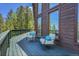 Outdoor seating with a small table, perfect for relaxing on the deck with views of the lush, surrounding nature at 11333 Conifer Mountain Rd, Conifer, CO 80433
