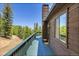 View from the deck with wood floors, offering views of the surrounding forest and beautiful landscape at 11333 Conifer Mountain Rd, Conifer, CO 80433
