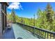 Spacious outdoor deck offering serene views of the surrounding forest at 11333 Conifer Mountain Rd, Conifer, CO 80433