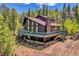 Charming two-story home with a large deck, surrounded by a lush forest providing great privacy and views at 11333 Conifer Mountain Rd, Conifer, CO 80433