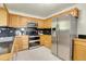 Bright kitchen with stainless steel appliances, granite countertops, and custom cabinetry at 11333 Conifer Mountain Rd, Conifer, CO 80433