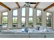 Spacious living room with exposed wood beams and large picture windows at 11333 Conifer Mountain Rd, Conifer, CO 80433
