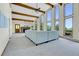 Open-concept living room featuring a fireplace and floor-to-ceiling windows at 11333 Conifer Mountain Rd, Conifer, CO 80433