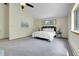 Spacious main bedroom with vaulted ceiling, gray carpeted floor, and comfortable white bed and bedding at 11333 Conifer Mountain Rd, Conifer, CO 80433