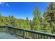 Expansive view from the deck, showcasing the natural landscape and mountain views in the distance at 11333 Conifer Mountain Rd, Conifer, CO 80433