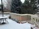 Exterior view of the back deck with a table and various potted plants covered in snow at 18336 E Amherst Dr, Aurora, CO 80013