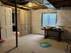 Unfinished basement space has a window and a framed wall in progress at 18336 E Amherst Dr, Aurora, CO 80013
