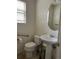 Bathroom features a sink, toilet, and window at 18336 E Amherst Dr, Aurora, CO 80013