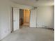 Bedroom with ample closet space and doorway leading to the hallway and upper level at 18336 E Amherst Dr, Aurora, CO 80013