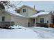 Charming two-story home with attached garage, snow-covered lawn, and inviting entrance at 18336 E Amherst Dr, Aurora, CO 80013