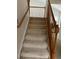 Carpeted staircase with wooden railing leading to the upper level of the home at 18336 E Amherst Dr, Aurora, CO 80013