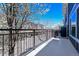 A view from the balcony showcases the neighborhood street and blooming trees at 9300 E Florida Ave # 1506, Denver, CO 80247