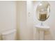 Powder room featuring a pedestal sink and a round mirror at 9300 E Florida Ave # 1506, Denver, CO 80247