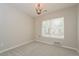 Cozy carpeted bedroom with chandelier, window, and neutral wall color at 9300 E Florida Ave # 1506, Denver, CO 80247