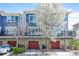 Modern townhome exterior featuring private garages, balconies, and manicured landscaping at 9300 E Florida Ave # 1506, Denver, CO 80247
