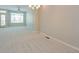 Bright living room filled with natural light, showcasing neutral carpet and a door to an outdoor patio at 9300 E Florida Ave # 1506, Denver, CO 80247