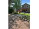 View of the backyard from a distance featuring mature trees, lush green grass, and a patio with pergola at 5201 E 127Th Dr, Thornton, CO 80241
