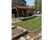 Inviting backyard with a pergola-covered patio, mature trees and a well-maintained lawn at 5201 E 127Th Dr, Thornton, CO 80241