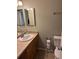 Functional bathroom featuring tan countertops, oak cabinets, a toilet, and a mirror at 5201 E 127Th Dr, Thornton, CO 80241