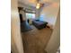 Bedroom with neutral paint and dark carpet features a bed, desk, and natural light from the window at 5201 E 127Th Dr, Thornton, CO 80241