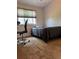 Well-lit bedroom featuring a comfortable bed and a dedicated workspace near the window at 5201 E 127Th Dr, Thornton, CO 80241