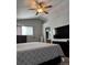 Well-lit bedroom featuring a ceiling fan, large bed, big TV, and closet at 5201 E 127Th Dr, Thornton, CO 80241