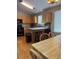 Kitchen features wooden cabinets, black appliances, a kitchen island, and plenty of natural light at 5201 E 127Th Dr, Thornton, CO 80241
