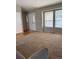 Bright living area featuring a large window, neutral walls, plush carpet, and natural light at 5201 E 127Th Dr, Thornton, CO 80241
