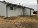 Backyard view of the home with neutral siding and well-maintained grounds at 6396 S Hill St, Littleton, CO 80120