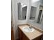 Bright bathroom featuring a single sink vanity with neutral countertops and a large mirror at 6396 S Hill St, Littleton, CO 80120