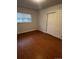 Cozy bedroom with wood flooring, closet, and a bright window at 6396 S Hill St, Littleton, CO 80120