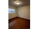 Simple bedroom featuring wood floors and a large window, offering a bright and airy feel at 6396 S Hill St, Littleton, CO 80120