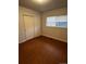 Bedroom featuring hardwood floors, closet space, and natural light from the window at 6396 S Hill St, Littleton, CO 80120