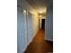 Hallway with multiple storage closets and modern lighting fixtures at 6396 S Hill St, Littleton, CO 80120