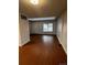 Spacious living room featuring beautiful wood floors and a large window for natural light at 6396 S Hill St, Littleton, CO 80120