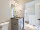 Modern bathroom with grey vanity, updated fixtures, and mirror at 10231 E 62Nd Pl, Denver, CO 80238