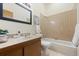 Cozy bathroom with a combination tub and shower and a wood vanity at 673 Brentwood St, Lakewood, CO 80214
