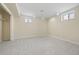 Carpeted bedroom with closet and two windows allowing natural light at 673 Brentwood St, Lakewood, CO 80214